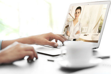 A person on a laptop engaged in a video call, discussing Notarization and Online Notaries.