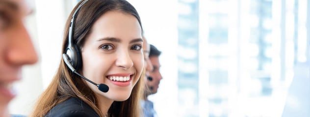 A woman wearing a headset in an office, providing customer service. Contact us for notary services.